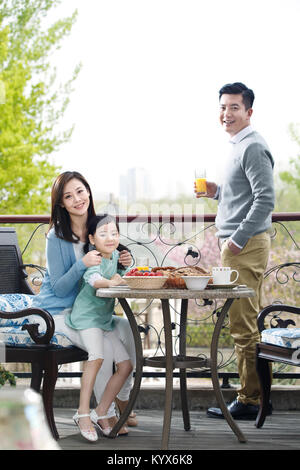 Des familles heureuses prennent un petit déjeuner sur la terrasse Banque D'Images