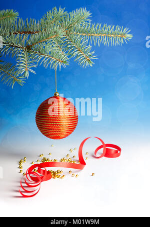 Décorations de Noël rouges sur fond dégradé bleu-blanc Banque D'Images