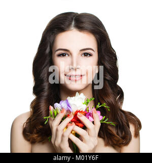 Cute Brunette Woman avec une parfaite du printemps, des fleurs colorées et Curly Hairstyle isolé sur fond blanc. Beau Modèle de Spa avec les cheveux ondulés Banque D'Images