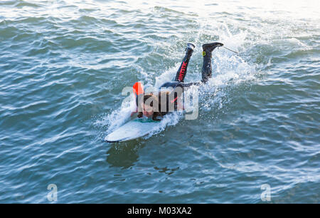 Bournemouth, Dorset, UK. 18 janvier, 2018. Météo France : après une nuit très ventée une belle journée ensoleillée à la plage de Bournemouth. Les surfeurs d'importantes vagues et mer agitée. Surfer allongé sur platine prête à une vague. Credit : Carolyn Jenkins/Alamy Live News Banque D'Images