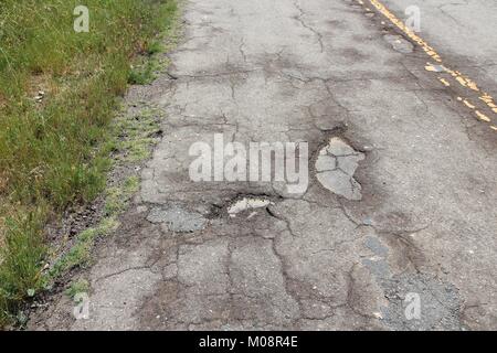 Route endommagée de Yokohl dur en Californie, Etats-Unis - asphalte fissuré blacktop avec poule et patches Banque D'Images