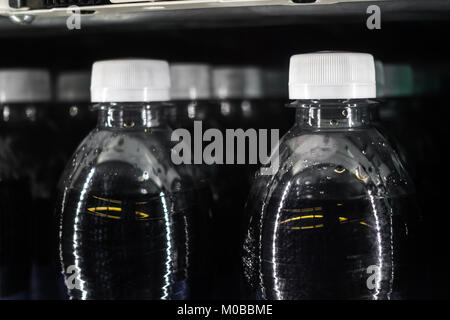 Bouteilles de boissons gazeuses en distributeur automatique de capsules de bouteilles blanc Lignes liquide noir Banque D'Images