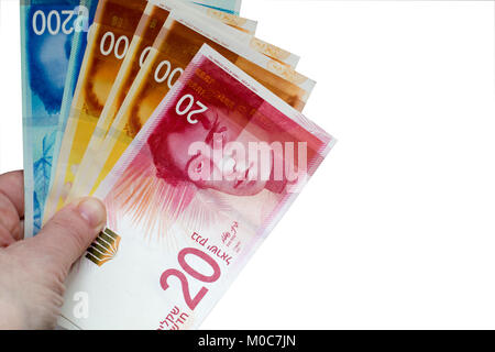 Femme tenant un tas de billets Nouveau shekel israélien dans ses mains. Fond blanc avec copie espace Banque D'Images
