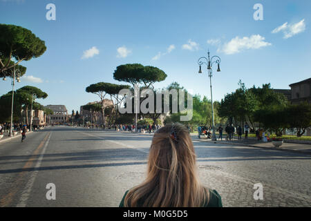 Le forum romain, la fille blonde à marcher en direction du Colisée. femme se rendant sur Via dei Fori Imperiali et Rome Banque D'Images