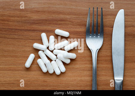 Concept de régime avec supplément pills, couteau et fourchette Banque D'Images