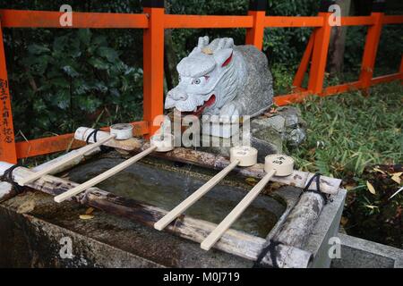 KYOTO, JAPON - 28 NOVEMBRE 2016 : les rituels de purification de l'eau printemps de Fushimi Inari Taisha à Kyoto, au Japon. Il y a plus de 10 000 torii ga Banque D'Images