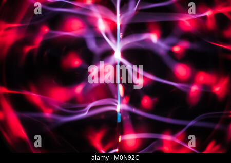 Résumé : La science gaz plasma chevrons et traces dans le noir Banque D'Images