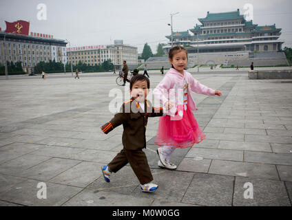 Au nord-coréen garçon vêtu de soldat avec sa sœur à choson-ot sur la Place Kim Il Sung, de la province de Pyongan, Pyongyang, Corée du Nord Banque D'Images