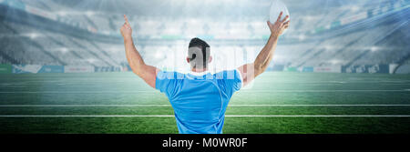 Image composite de rugby player cheering avec la balle Banque D'Images