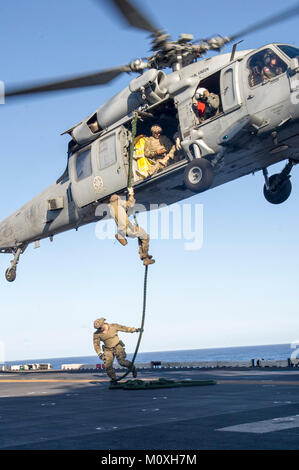 Océan Pacifique (jan. 20, 2017) Les membres affectés à l'unité mobile de destruction des engins explosifs (EODMU) 11 corde rapide d'un MH60S Knight Hawk affecté à la "Black Knights" de l'Escadron d'hélicoptères de combat de la mer (HSC) 4 sur le pont d'envol du navire d'assaut amphibie USS America (LHA 6) au cours d'un exercice de passage (PASSEX) avec la classe Nimitz porte-avions USS Carl Vinson (CVN 70). Amérique latine, une partie de l'Amérique du groupe amphibie, à 15e Marine Expeditionary Unit, est de retour d'un déploiement de 7 mois aux États-Unis 3e, 5e et 7e flotte secteurs d'opérations. (U.S. Navy Banque D'Images