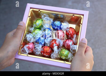 Close up d'un assortiment de chocolats Lindt Lindor en case de couleur or Banque D'Images