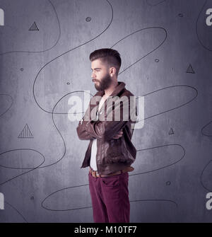 Un jeune homme moderne à la mode des vêtements de style décontracté making expressions du visage tandis que l'article Banque D'Images