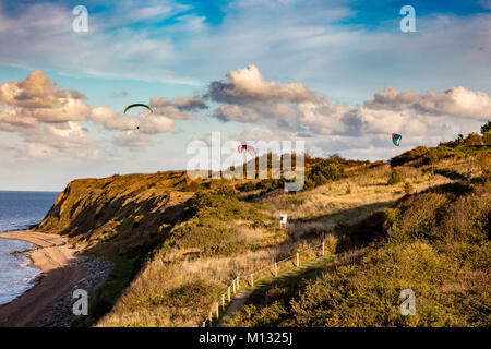 Les planeurs para profiter de la brise de terre qui leur ascenseur au-dessus des falaises à Bishopstone, Herne Bay, Kent, UK Banque D'Images