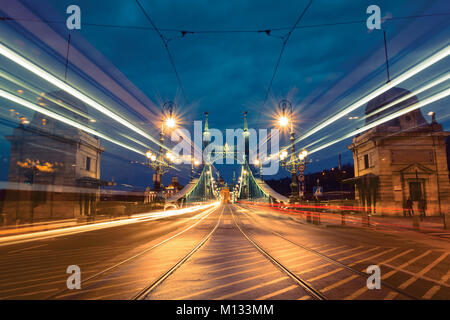 Le trafic de nuit light trails sur pont de la liberté, Budapest Banque D'Images