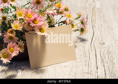 Carte vierge de texte près du panier avec de délicates fleurs de chrysanthèmes Banque D'Images