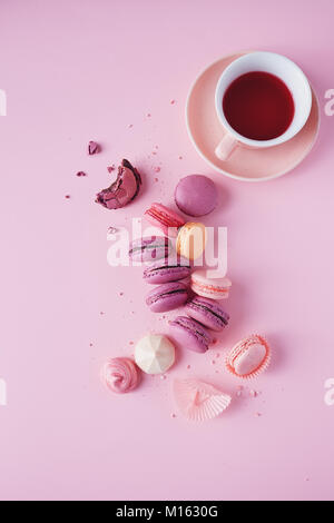 Sweet french macarons et meringues sur fond rose. Banque D'Images