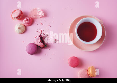 Sweet french macarons et meringues sur fond rose. Banque D'Images