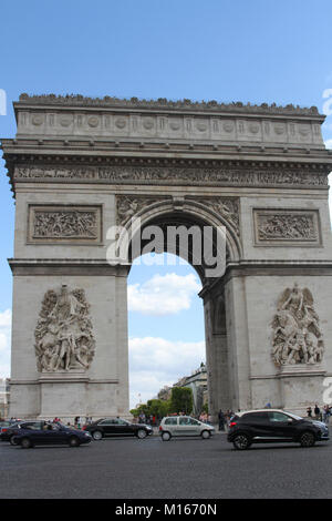 L'Arc de Triomphe de l'Etoile, l'Arc de Triomphe de l'avant avec des voitures qui passent dans la rue, Paris, France. Banque D'Images