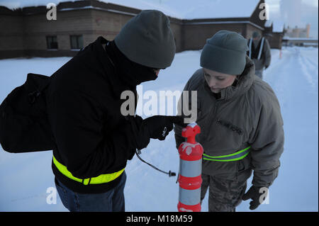 L'U.S Air Force 354e Escadron des Forces de sécurité attaque Après la reconnaissance (PAR) contrôles de l'équipe d'agents chimiques sur un morceau de papier de détection chimique M8 sur 26 janvier 2018, au cours de l'exercice Arctic Gold 18-4, à Eielson Air Force Base, en Alaska. Après une attaque sur la base par les équipes sont chargées d'effectuer des recherches autour de leur installation immédiate pour les dangers tels que les munitions non explosées, preuve d'une attaque chimique et des dommages à l'infrastructure. (U.S. Air Force Banque D'Images