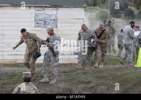 La Garde Nationale de Californie est le Sgt. James W. Peterson, Intel &AMP ; le maintien en puissance Co, 40e Division d'infanterie, à gauche, et Sgt. Fernando Carmona, 1113th Transportation Company, 340e Bataillon de soutien de la Brigade, 224e Brigade de soutien, l'assistance de leurs sponsors après la sortie d'une chambre à gaz au cours de la composition chimique, biologique, radiologique et nucléaire (CBRN) cas de la California's 2017 Concours meilleur guerrier 1-5 novembre 2016, au Camp de San Luis Obispo, San Luis Obispo, Californie. (Photo de Garde Nationale d'armée/Sgt. Andres 1ère classe J. Viveros) Banque D'Images