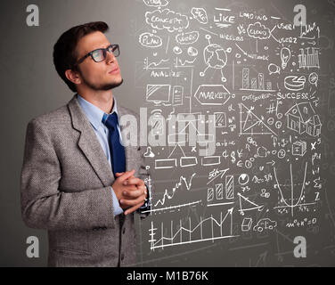 Young man looking at bourse graphiques et symboles Banque D'Images