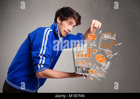 Handsome young man holding laptop avec des graphiques et statistiques Banque D'Images