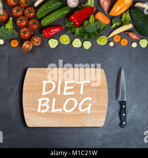Blog concept de régime. Les légumes, planche à découper en bois vide et couteau de chef sur fond noir pour l'étalage des produits Banque D'Images