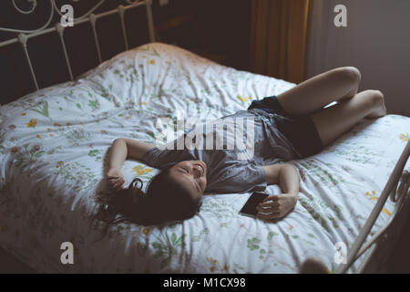 Woman in bedroom Banque D'Images