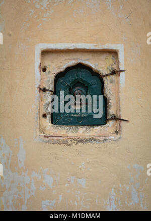 Petite fenêtre sur mur de brique de l'ancien palace à Jaipur, Inde. Banque D'Images