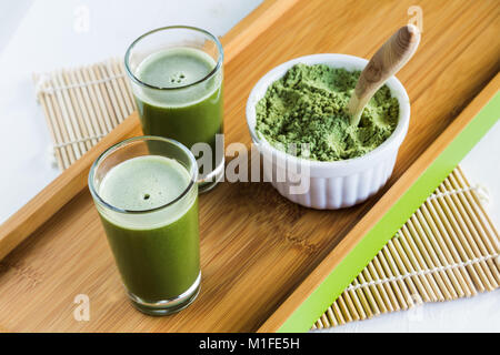 Des coups de feu avec de la poudre de Wheatgrass agropyre et cuillère en bois Banque D'Images