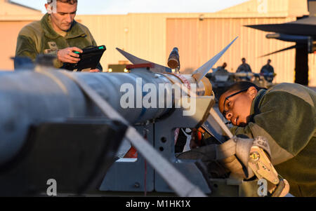 Aviateurs de la 57e Groupe d'entretien effectuer une inspection sur un AMRAA AIM-120 au cours de l'équipe de chargement trimestriel compétition à Nellis Air Force Base, Nevada, le 5 janvier 2018. Les équipes étaient évaluées sur la vitesse et la précision lors du chargement d'armes à sous-munitions sur leur appareil. (U.S. Air Force Banque D'Images