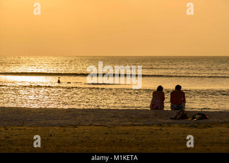 Coucher du soleil des Caraïbes. Les gens sur la rive de Boca Catalina, Aruba Banque D'Images