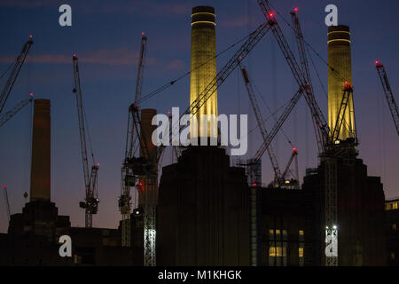 Londres, Royaume-Uni. 30Th Jan, 2018. Grues de construction lumineux entourent Battersea powerstation au coucher du soleil. Sir Giles Gilbert Scott, immeuble Art Déco monumental est d'être transformé en un parc de 17 hectares qui abritera l'Apple campus britannique et un immeuble conçu par Frank Gehry. Credit : Mark Kerrison/Alamy Live News Banque D'Images