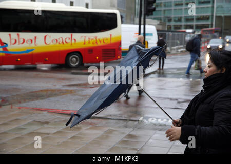 London,UK,31 janvier 2018,une dame se dispute avec son parapluie comme il souffle l'intérieur vers l'extérieur pendant les fortes averses de pluie et de vent à Victoria Londres©Keith Larby/Alamy Live News Banque D'Images