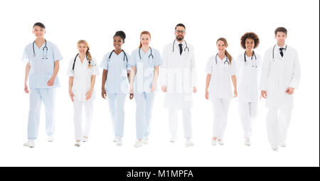 Portrait of Happy Doctors Walking in front of White Background Banque D'Images