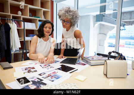 Deux femmes creatives discuter dans un bureau de mise en page magazine Banque D'Images