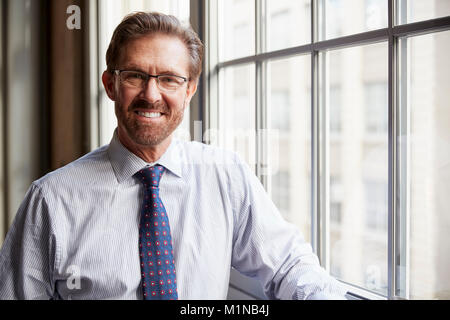 Senior businessman in shirt smiling to camera, Close up Banque D'Images