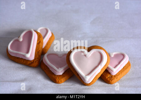 Gingerbread cookies en forme de cœur décoré de glaçage rose, un parfait Saint-valentin traiter Banque D'Images