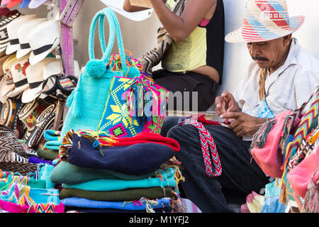 Cartagena, Colombie - Janvier 23th, 2018 : Un colombien artisan artisan en tricot de laine à la main et sacs en coton dans la Plaza de Bolivar à Carthagène. Banque D'Images