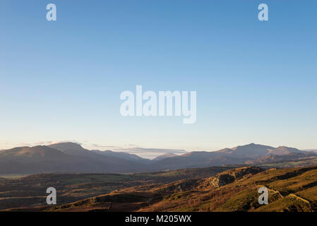 Montagnes de Snowdonia sous un ciel bleu clair vu de collines près de Harlech, Nord du Pays de Galles. Mont Snowdon vers la droite. Banque D'Images