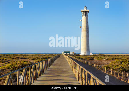 Passerelle en bois pour piétons près de la plage de Morro Jable phare dans le coucher du soleil, la lumière chaude de l'île de Fuerteventura, Espagne Banque D'Images