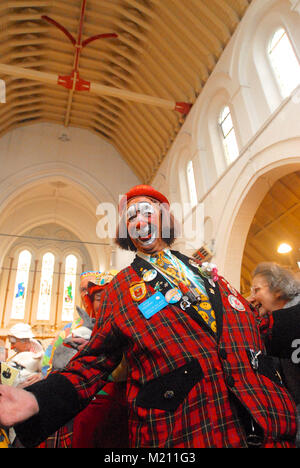 M. Woo (clown et vice-président honoraire de clowns International) sourire et rire à la fin de la 62e assemblée annuelle de l'Église au service de clown Grimaldi Holy Trinity Church, Dalston, East London. Le service, qui a été une tradition annuelle depuis 1946, est conservé dans la mémoire de Joseph Clown 'Joey' Grimaldi (1778-1837), le plus célèbre clown anglais qui est né et a joué dans Londres. L'unique service de l'église a lieu le premier dimanche de chaque mois de février et une couronne est posée en l'honneur de Grimaldi. Banque D'Images