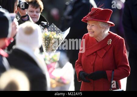 La reine Elizabeth II salue des wellwishers qu'elle fréquente l'église St Pierre et Paul à West Newton, Norfolk, pour un dimanche matin. Banque D'Images