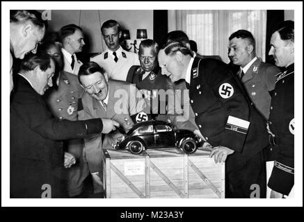 HITLER VOLKSWAGEN KDF-WAGEN , dans les années 1930, le Dr Porsche montrant Fuhrer Adolf Hitler et les hauts responsables nazis, un modèle à échelle de son moteur refroidi par air unique et un design inspiré... "La voiture du peuple", la Volkswagen "Beetle" KDF Wagen Fallersleben Wolfsburg Allemagne Archive image de propagande nazie Banque D'Images