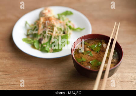 Un bol de soupe miso épicé et une assiette de salade de légumes japonais dans un restaurant végétalien, de l'alimentation encore la vie sur une table en bois. Kyoto, Japon. Banque D'Images