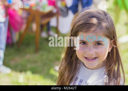 Portrait en extérieur d'une belle petite fille avec visage peint Banque D'Images
