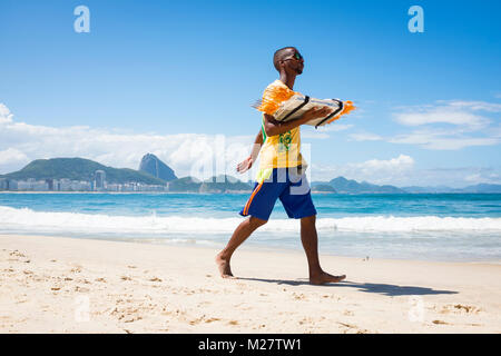 RIO DE JANEIRO - le 21 mars 2017 : Vendeur de plage à pied le long de la plage de Copacabana la vente de crevettes grillées Banque D'Images