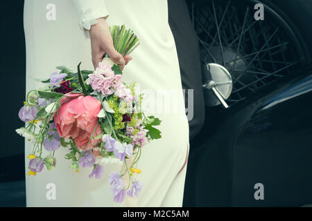 Bride holding bouquet de mariage, mid section Banque D'Images