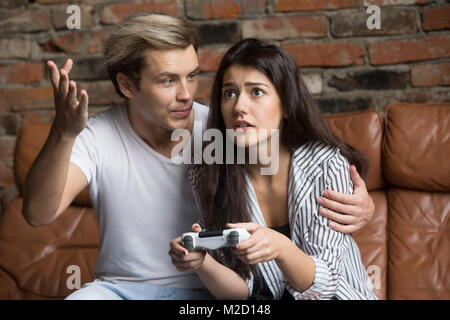 Homme Femme gronder pour perdre jeux vidéos à la maison Banque D'Images