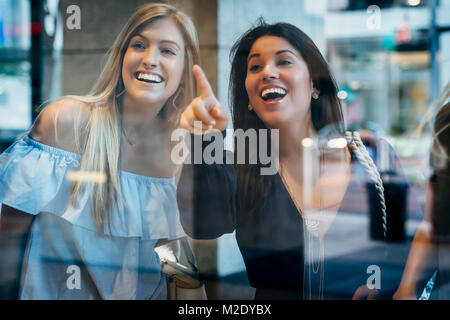 Smiling women window shopping Banque D'Images